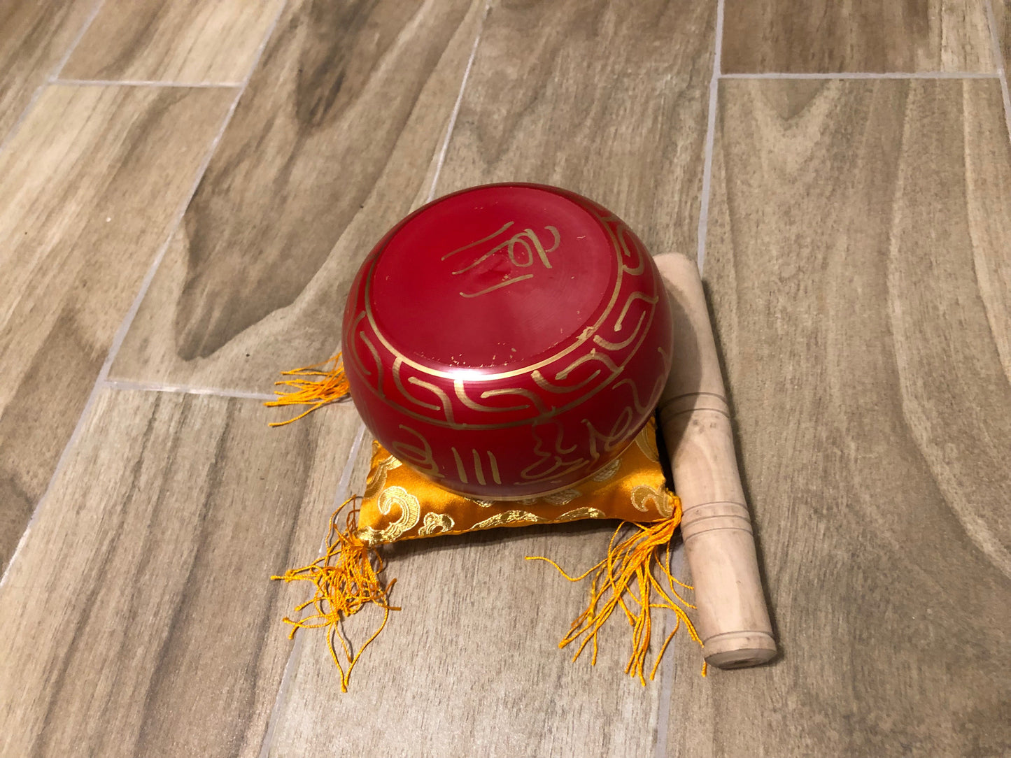 Charming Perfection Red Tibetan Buddha Embossed Chakra Signing Bowl with mallet and cushion on Wood tile background for Gift, Birthday, Anniversary, Wedding, Christmas Friendship and Holiday