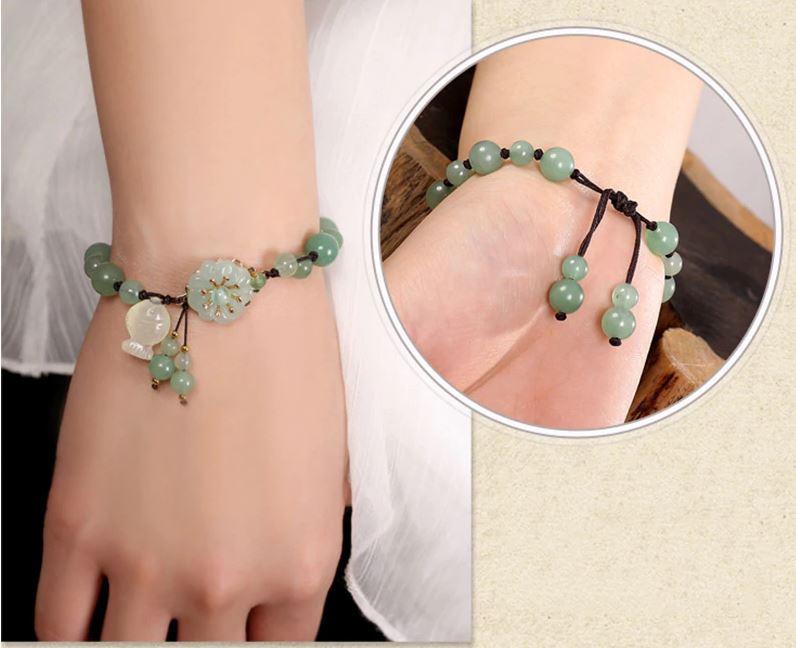 Charming Perfections High Quality Natural Green Jade flower fish bracelet Jewelry around wrist with brown background Pure Natural Stone Crystal Beauty Jewelry. Perfect for Birthday Gifts, Anniversary, Black Friday, Christmas, or any Occasion. Perfect Present for a Loved one. Fashion and Style. Very Fashionable for that special someone.