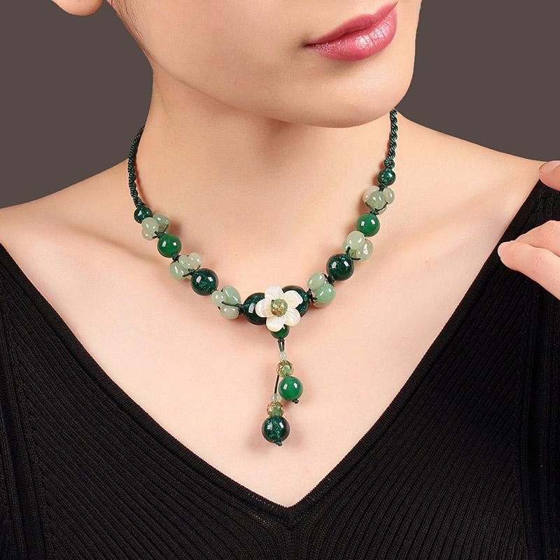 Charming Perfections High Quality Natural Green Jade Emerald Flower necklace Jewelry around neck with black sweater background Pure Natural Stone Crystal Beauty Jewelry. Perfect for Birthday Gifts, Anniversary, Black Friday, Christmas, or any Occasion. Perfect Present for a Loved one. Fashion and Style. Very Fashionable for that special someone.