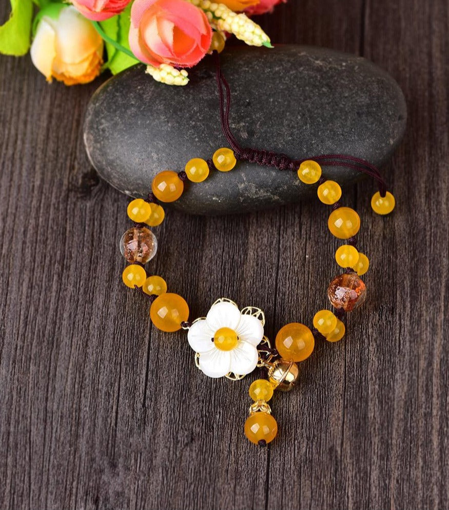 Charming Perfections Handmade Yellow Agate Crystal Natural Stone Bracelet Jewelry on rock with wooden background and flowers for Gift, Birthday, Anniversary, Wedding, Christmas Friendship and Holiday