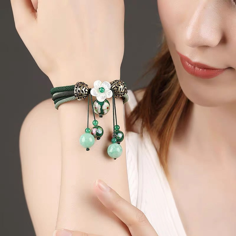 Charming Perfections High Quality Natural Green Jade flower bracelet Jewelry on wrist with grey background Pure Natural Stone Crystal Beauty Jewelry. Perfect for Birthday Gifts, Anniversary, Black Friday, Christmas, or any Occasion. Perfect Present for a Loved one. Fashion and Style. Very Fashionable for that special someone.