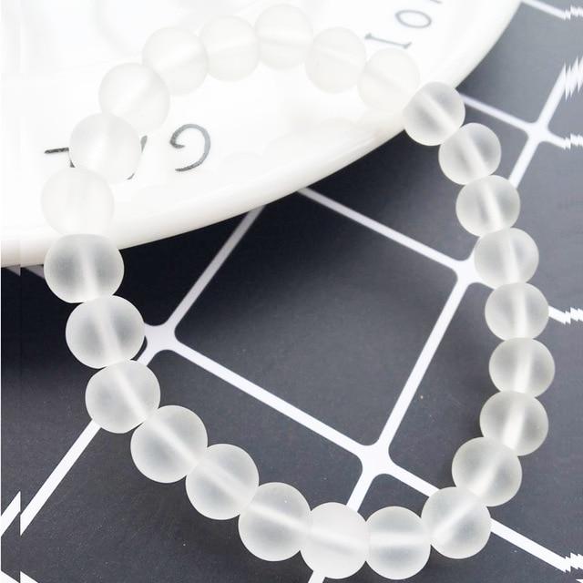 Charming Perfections Matte Clear Chakra Natural Crystal Stone Stretch Bracelets 8mm Jewelry with Gray Tile background for Gift, Birthday, Anniversary, Wedding, Christmas Friendship and Holiday.